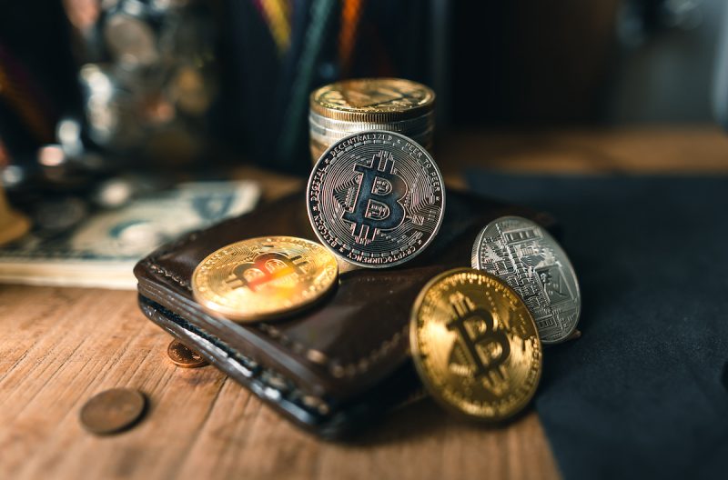 bitcoin-coins-on-a-wooden-desk-at-home-2021-10-21-04-34-32-utc-2.jpg