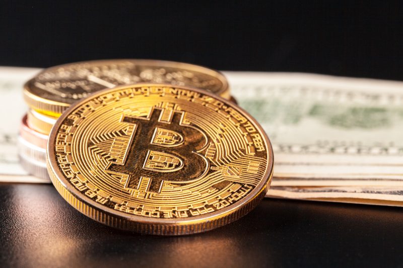 golden-bitcoin-coin-and-us-dollars-2021-12-15-01-35-24-utc.jpg